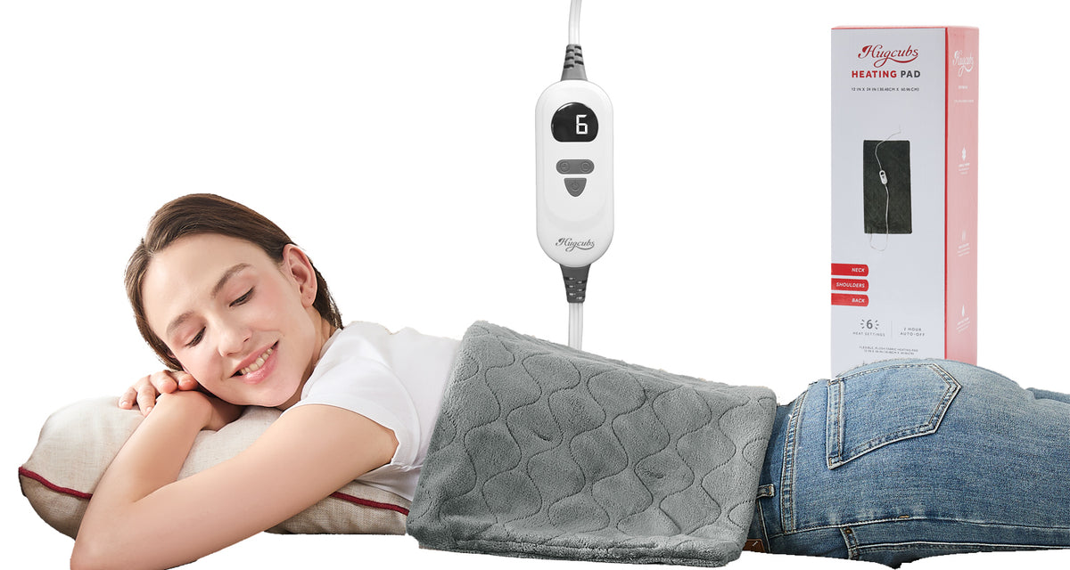 A woman resting awake with a HugCubs portable heating pad across her back.